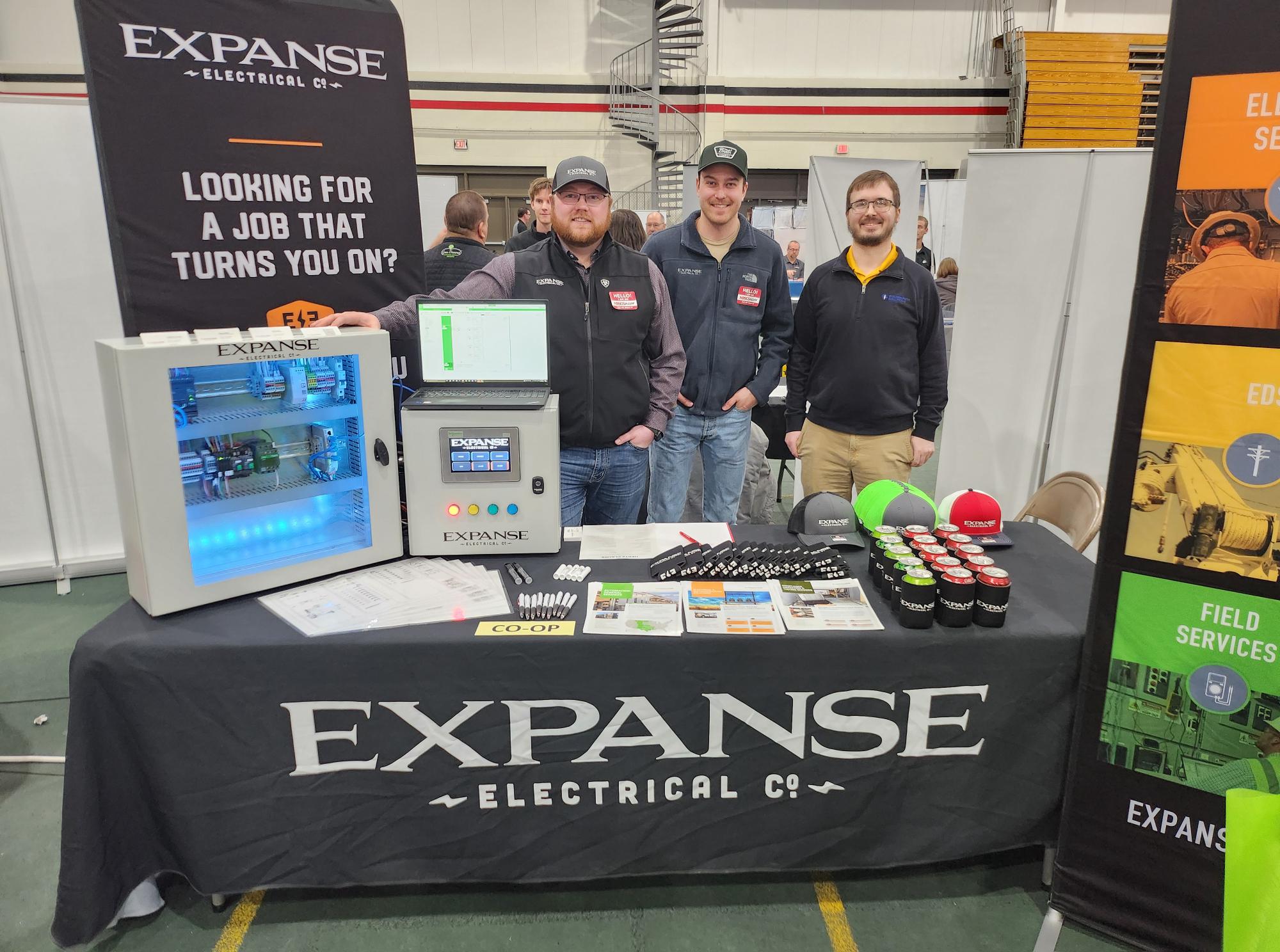 NDSCS Career Fair Derek A Golden Path employee and two Expanse employees are pictured at the Expanse table at the NDSCS Career Fair