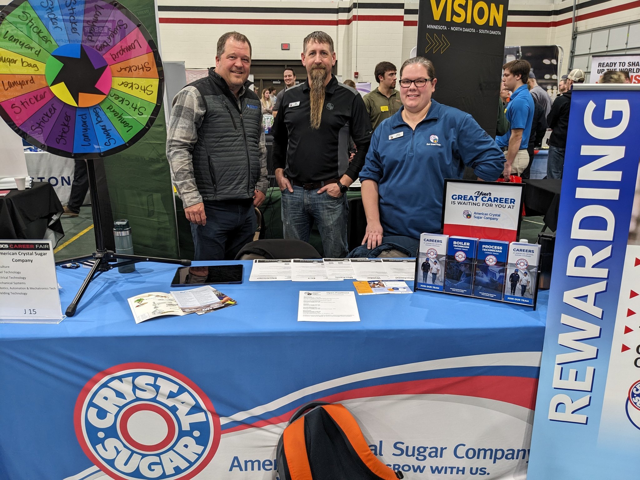 NDSCS Career Fair Ryan A Golden Path employee at two American Crystal Sugar employees are pictured at the American Crystal Sugar table at the NDSCS Career Fair